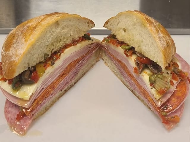 PREMIUM MUFFULETTA SANDWICH ON SUB ROLL.